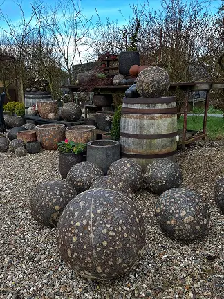 Runde stenkugler og tønder udstillet udendørs. brugt på forsiden.